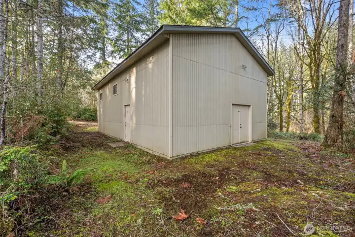 High-ceiling shop or garage offering flexible storage and workspace.