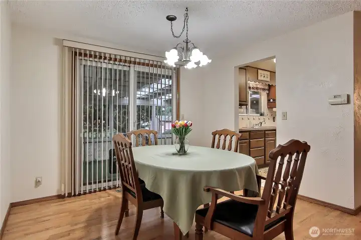 Dining area leads to covered porch area and back yard