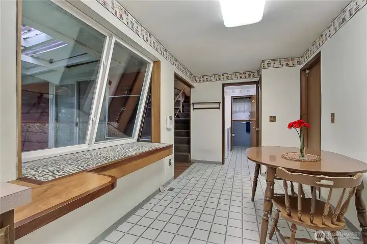 Bay window provides easy access for entertaining to covered porch area