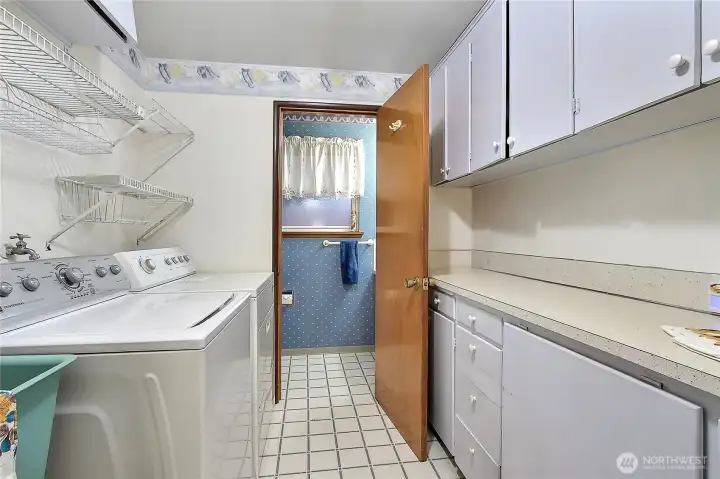 Walk in pantry in laundry area leads to half bath