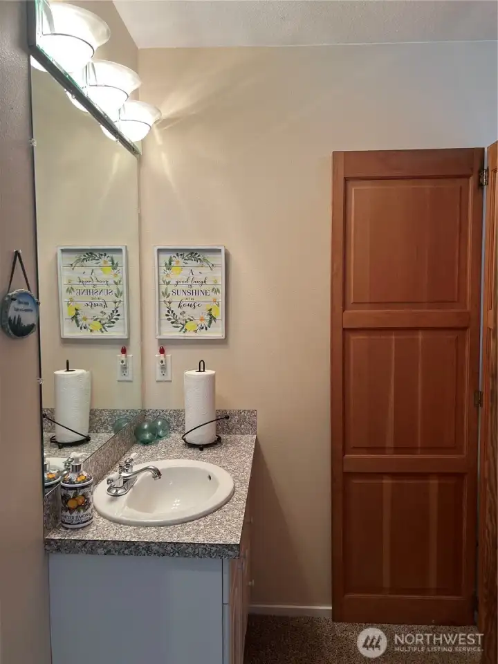 Sink just outside the bathroom for bathroom with shower.