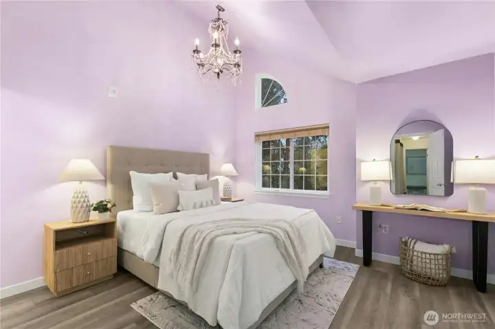 Step upstairs to the primary bedroom, complete with vaulted ceilings. Let in the natural light, and enjoy the designer lighting above.
