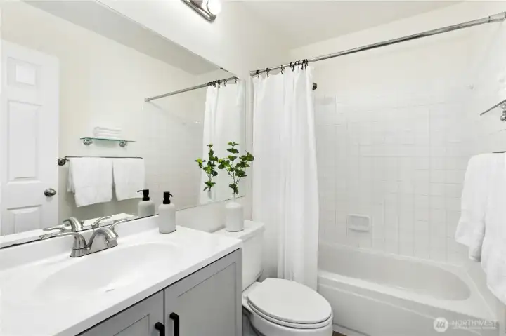 Step into the primary ensuite, take a bath, and enjoy the new vanity, floors, and lighting.