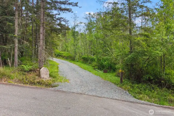 Gravel driveway entrance already installed, providing direct access into this secluded wooded 10-acre parcel.