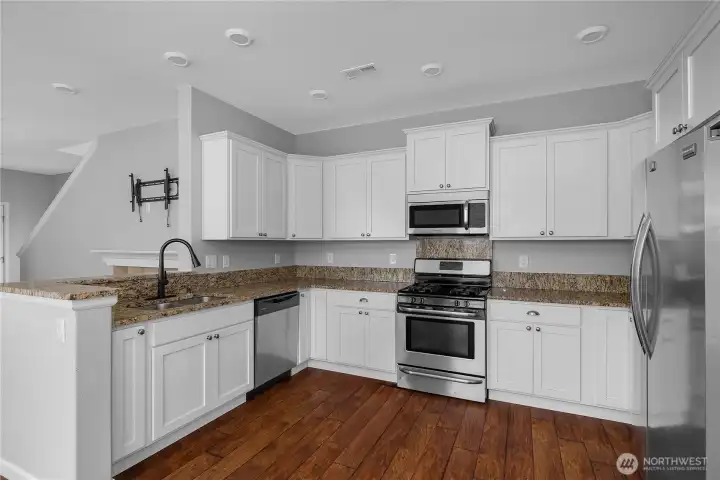 designed with modern living in mind, the kitchen serves as the hub of the home with generous storage, abundant prep space, and sightlines throughout the main living areas.
