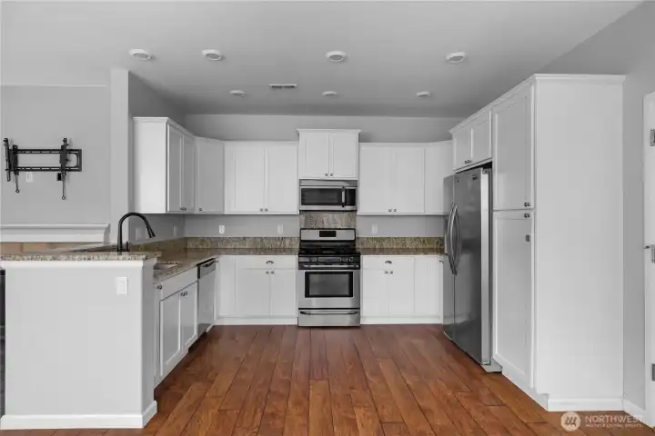 The spacious kitchen offers abundant cabinetry, generous counter space, and everything you need for every day cooking and living