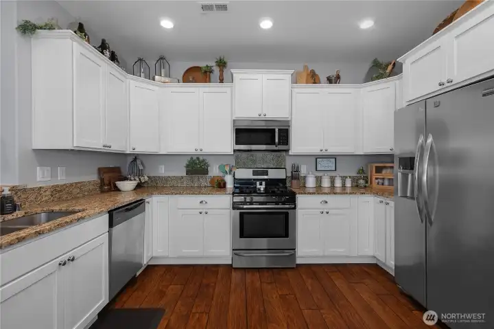 The spacious kitchen offers abundant cabinetry, generous counter space, and everything you need for every day cooking and living