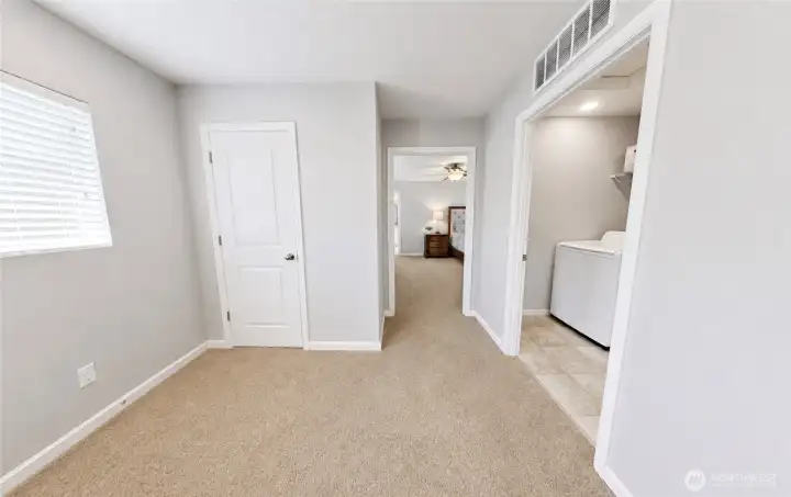 At the top of the stairs tucked away from the secondary bedrooms, the spacious primary suite offers a private retreat designed for rest and relaxation.