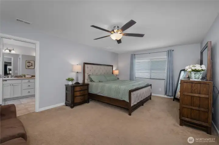 generously sized and filled with natural light, the primary bedroom provides plenty of space to unwind and recharge.