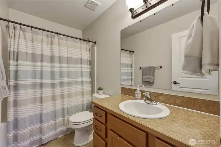 Full bathroom upstairs is clean and cared for; drawers on either side of the vanity allow for storage for all. Full bathroom upstairs is clean and cared for; drawers on either side of the vanity allow for storage for all.