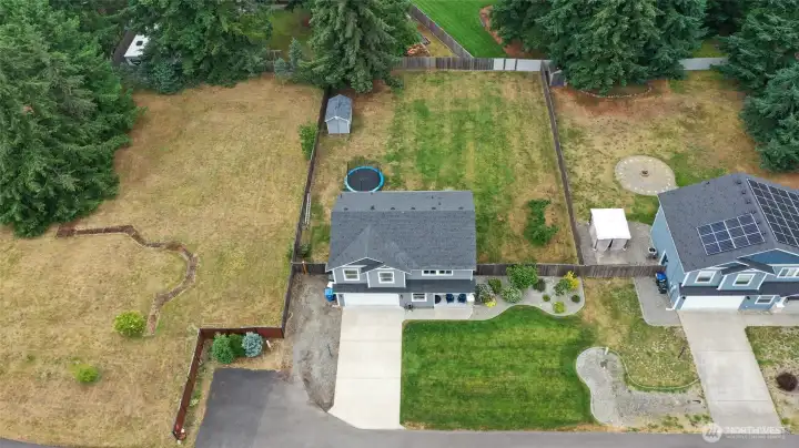 Aerial showing the placement of the lot with no proximal neighboring house on the left, the extra paved parking spots, gravel RV/boat area and wide gate, all on a dead-end street. Aerial showing the placement of the lot with no proximal neighboring house on the left, the extra paved parking spots, gravel RV/boat area and wide gate, all on a dead-end street.