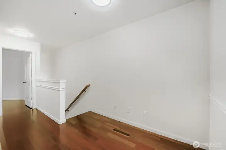 Warm hardwood floors welcome you home.