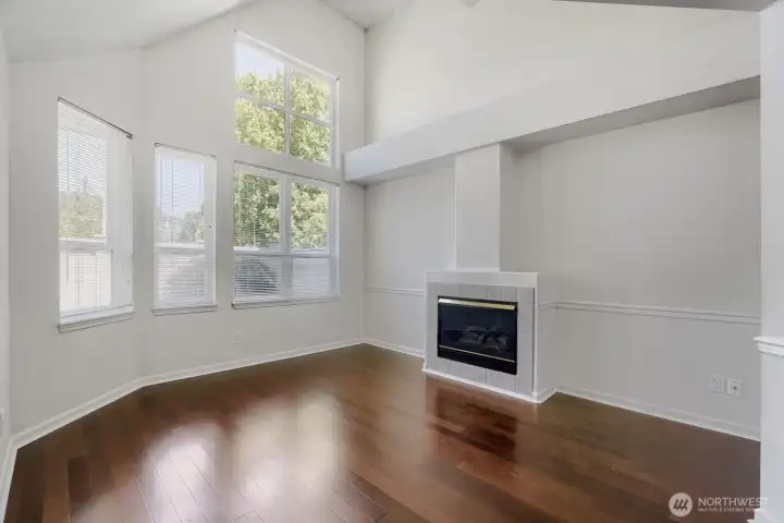 Cozy fireplace anchors this open and inviting gathering space.