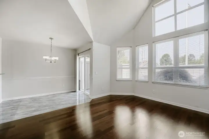 Soaring ceilings and oversized windows fill the room with natural light.