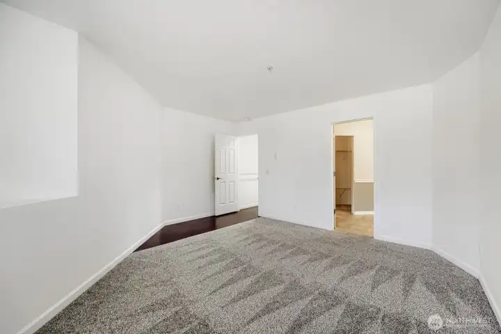 Spacious primary suite offers room for a king-sized bedroom set, sitting area, or home office nook.