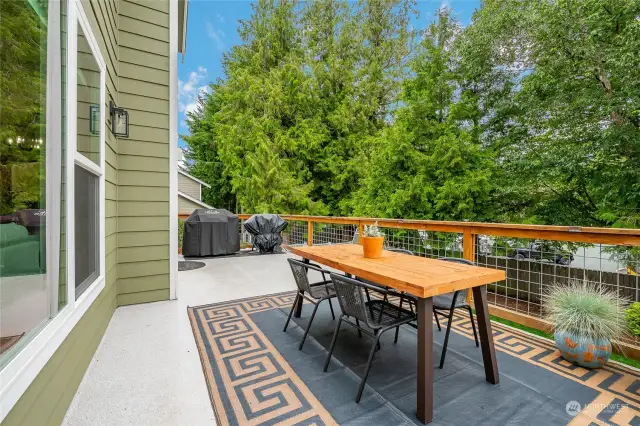 Spacious deck overlooking the backyard with space for BBQing and entertaining!