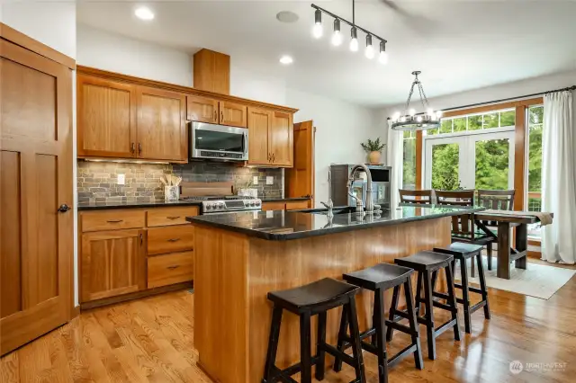Kitchen features granite counters, stainless appliances and walk-in pantry.  Hardwood floors throughout main floor.