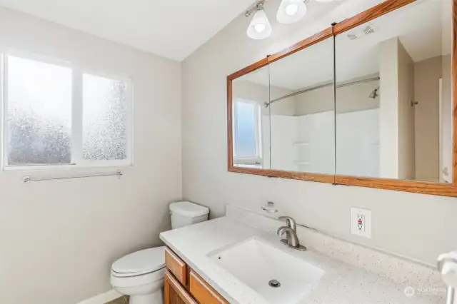 Bathroom with door to living room and primary.