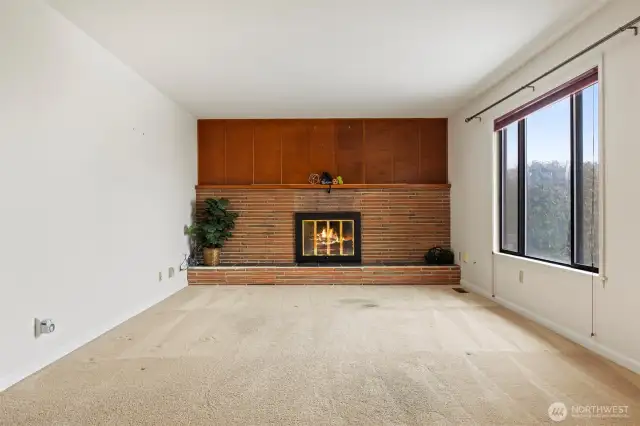 Living Room- with wood fireplace- original wood floors under carpet