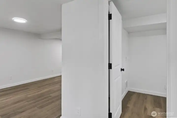 Possible lower unit entryway, third bedroom ahead, rec room to the left