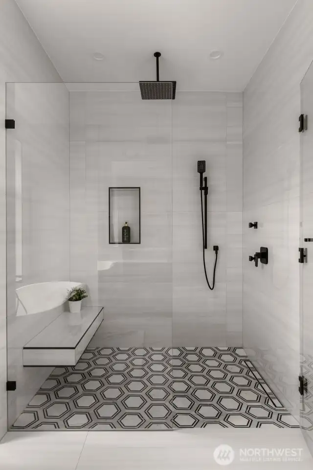 Curbless shower in the primary suite with high end plumbing fixtures