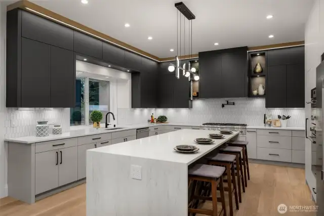 High end chef's kitchen with an oversized island and an abundance of counter space and storage.