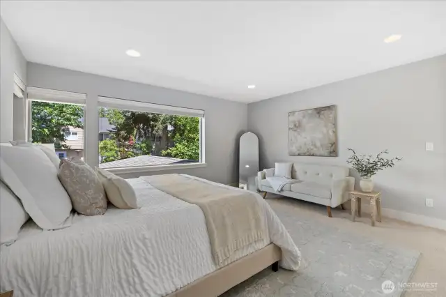 Expansive Primary bedroom easily fits a King size bed and seating area. Custom wood blinds included.