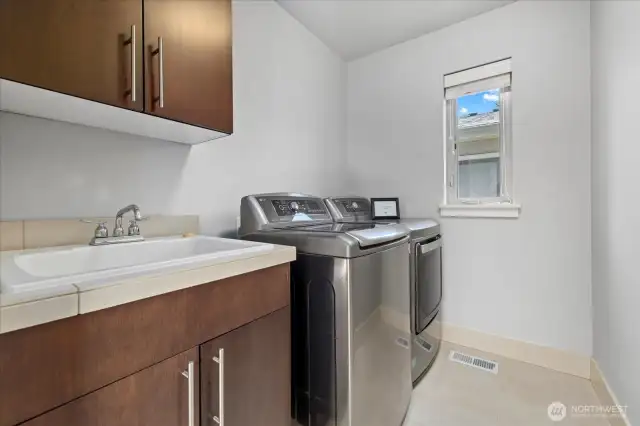 Convenient 2nd floor laundry with a full-size utility sink and great storage.