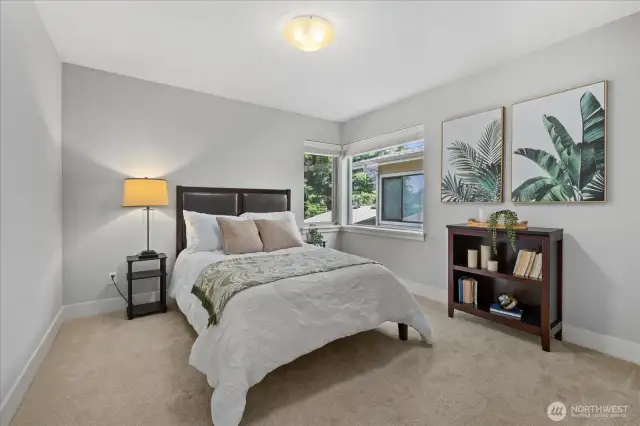 Bedroom #2 with large windows, custom wood blinds and a double door closet.