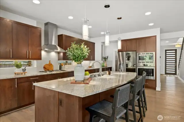 Chef-inspired kitchen with SS appliances, granite counters, an entertainment sized island and gas cooktop make cooking a dream!