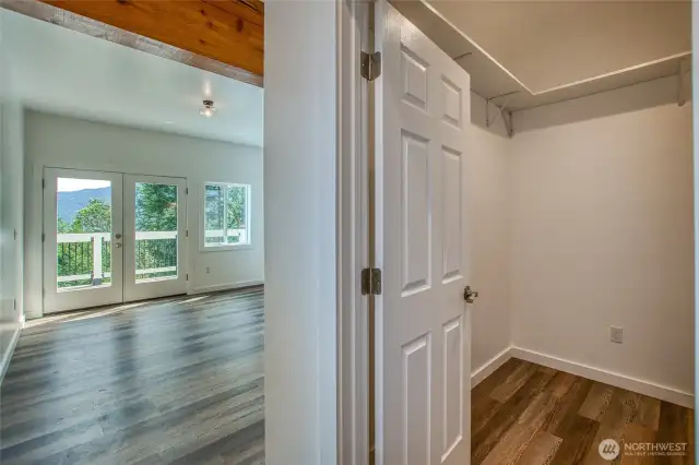 1 of 2 primary bedrooms on lower level with walk-in closet, primary bathroom, and washer/dryer.