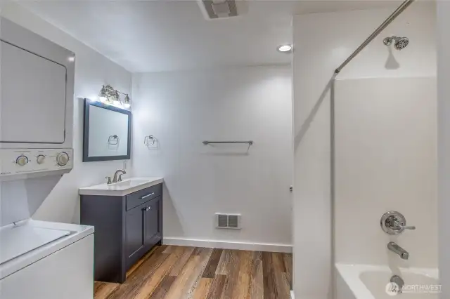 Full bathroom off primary bedroom with laundry.