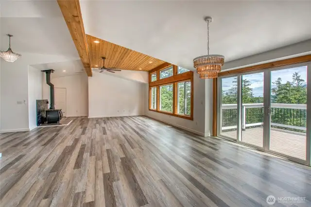 Living room with fire place, lots of light, and open to a spacious deck.