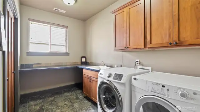 Large utility room with folding shelf, storage, central vac