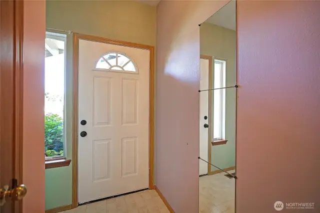 entry way with coat closet and entry to garage