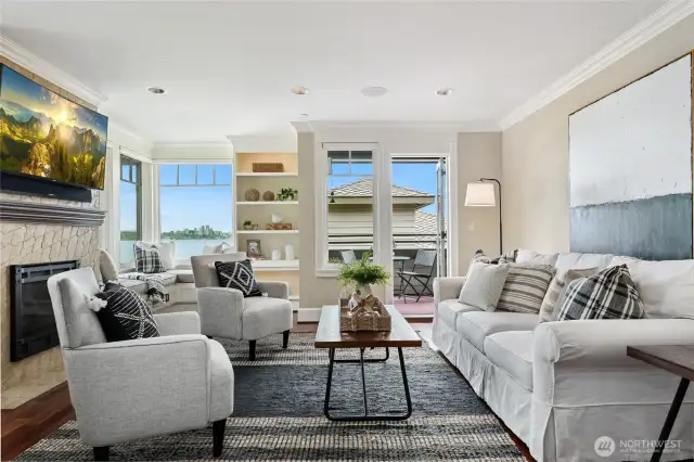 The main living room is open and spacious. Gas fireplace, cozy window seat and loads of built-ins.