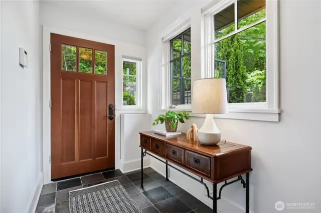 The entry is a means to the view and comfy spaces. A door on the left leads to the private garage. 2nd parking space is in the common garage below.