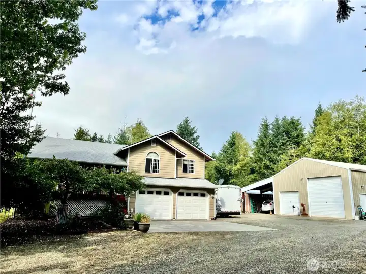 Left of the garage doors is the staircase to the covered porch/deck