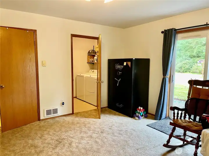 Base of the stairs to Closed door is 1/2   bath, facing me is utility room and beside, left me garage access. Gun safe stays!