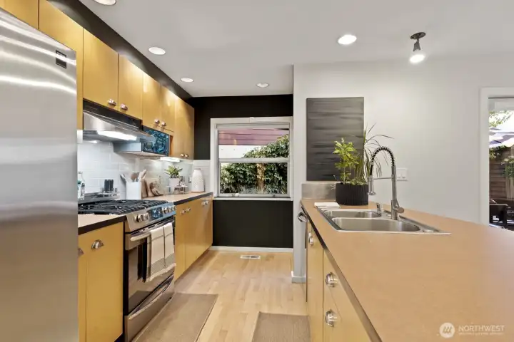 High-end stainless steel appliances, a newer gas range, and tons of storage space make this kitchen a dream to cook in.