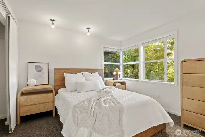 The primary looks out to serene treed views - imagine waking to singing birds and rustling leaves as the city comes to life around you!