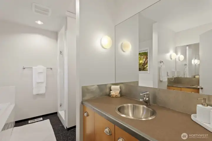 Dual vanities and separate spaces for sinks/bathing utilize every inch of space.