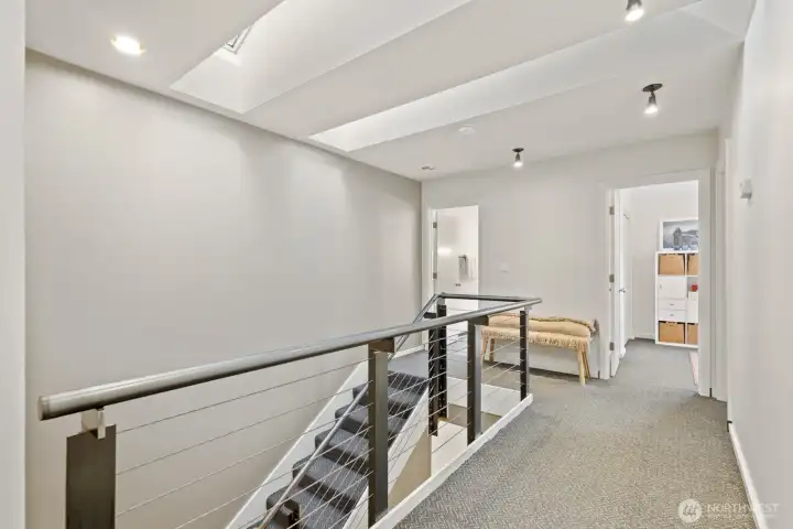 The upstairs hallway stays beautifully bright thanks to large skylights - plus, more room to display your favorite art pieces!