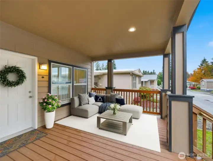 Second porch angle showcases additional seating and vibrant greenery, highlighting the generous outdoor space this home offers for easy, comfortable living. (photo virtually staged)