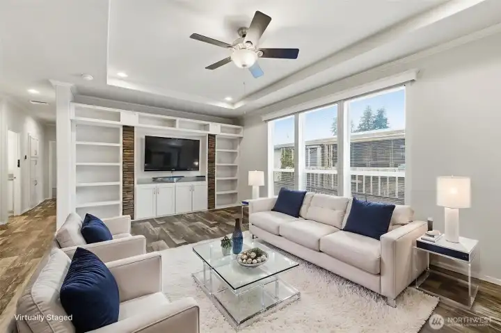 Bright and inviting living room features a sleek built-in media wall and contemporary finishes for effortless style. (Photo virtually staged)