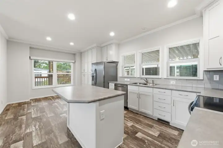 Spacious kitchen with a large center island offers comfortable seating and plenty of room to gather with friends & loved ones.