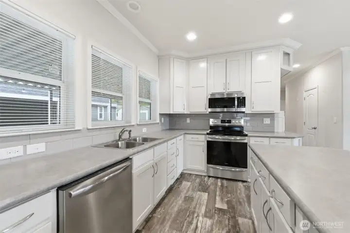 Thoughtfully planned kitchen with ample counter space, storage, and bright windows for a fresh, welcoming feel.