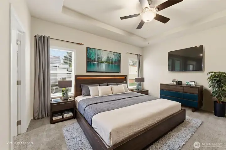 Elegant primary suite with tray ceiling, walk-in closet, and spa-inspired bath for comfort and relaxation.