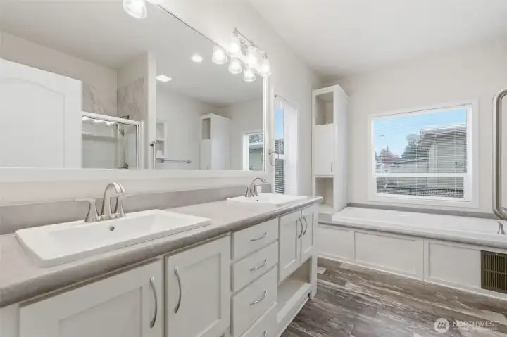 Bright and spacious primary bath offers plenty of counter space and room to move comfortably.