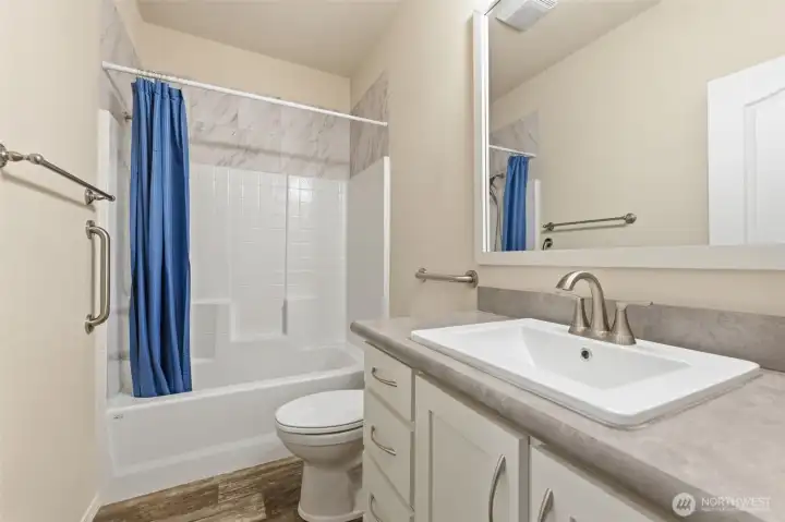 ull guest bathroom with shower-tub combo, comfort height toilet & modern finishes ensures both comfort and convenience.